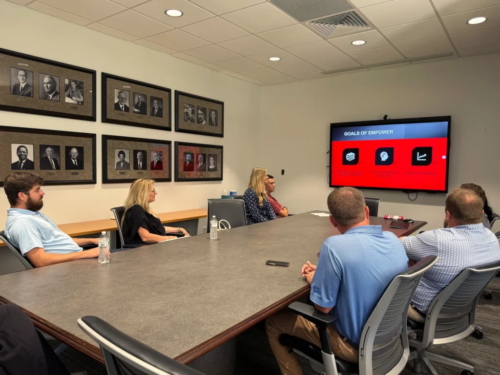 D&F Charity Trust team viewing EMPOWER Program presentation at a table.